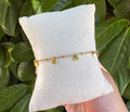 Bracelet de cheville pampilles dorées sur coussin