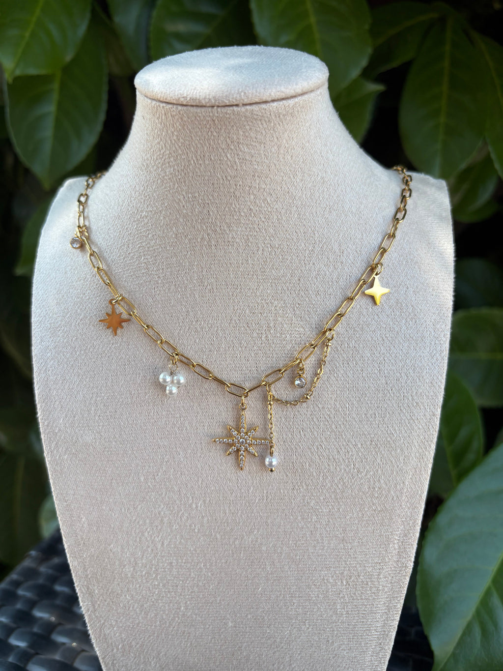 Collier breloques étoiles perles et strass doré sur présentoir